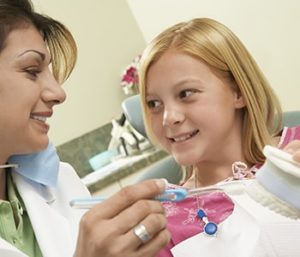 Dentist and girl smiling