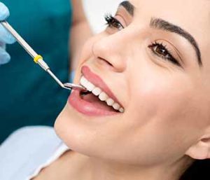 Periodontal Disease Treatment - Dentist is examine patient's teeth